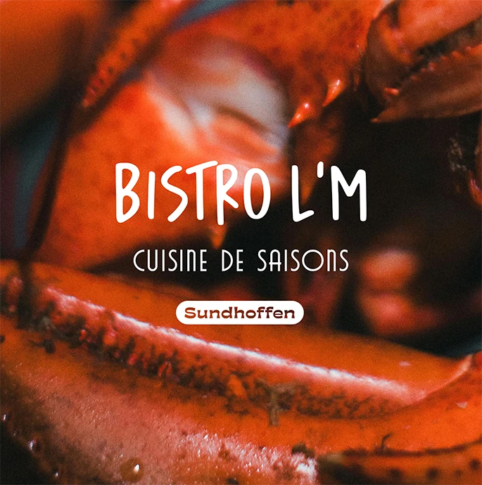 Logo Bistro L’M et mention Sundhoffen sur une photo de homard en gros plan, direction artistique du restaurant alsacien